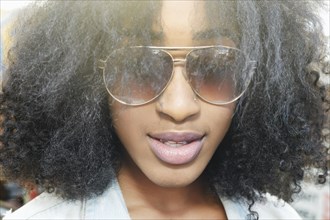 Close up of mixed race woman wearing sunglasses