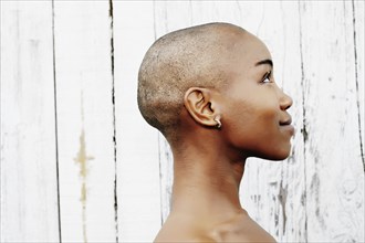 Profile of naked bald black woman