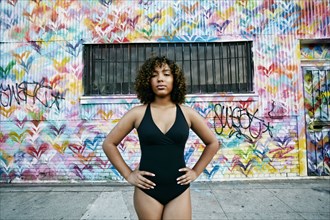 Portrait of confident mixed race ballet dancer in city