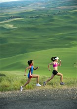 Women runners running in countryside