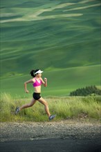 Mixed race runner running in countryside