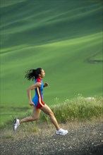 Mixed race runner running in countryside