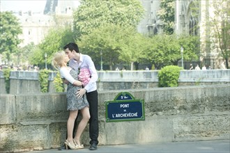 Caucasian couple kissing on Pont de L'Archeveche
