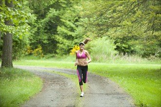 Caucasian woman running on remote path
