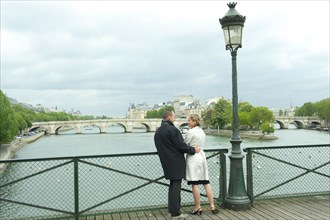 Caucasian couple talking on bridge