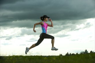 Japanese woman running in field