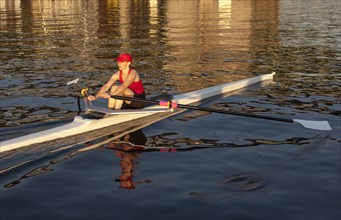 Person rowing sculling boat on river