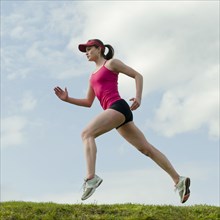 Mixed race teenager running outdoors