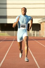 Black runner running on track