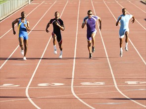 Runners running on track in race