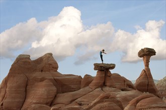 Caucasian woman practicing yoga on top of rock formation