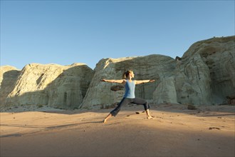 Caucasian woman practicing yoga in desert