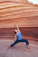 Caucasian woman practicing yoga outdoors