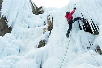 Caucasian man climbing ice