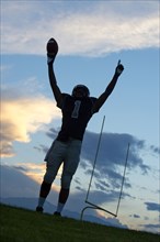 African American football player cheering in game