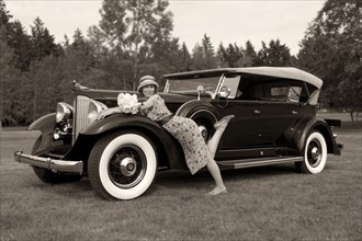 Caucasian woman on vintage car