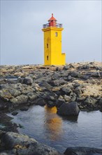 Lighthouse overlooking rocky landscape
