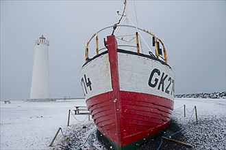 Ship docked near lighthouse