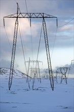 Power lines in snowy landscape