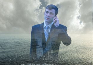 Double exposure of businessman over ocean