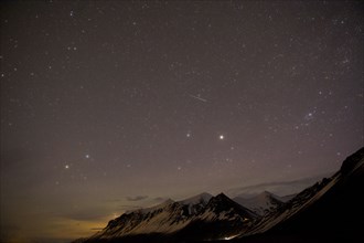 Starry sky over arctic landscape