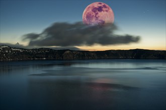 Moon over dark cloud at Crater Lake