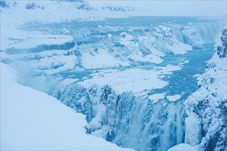 Snowy cliffs and waterfall