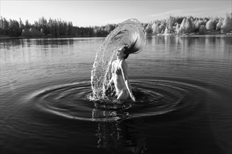 Korean woman flipping hair in lake