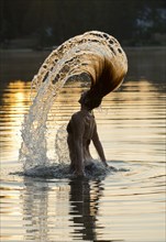 Korean woman flipping hair in lake