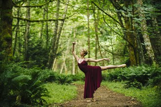 Caucasian woman dancing in forest