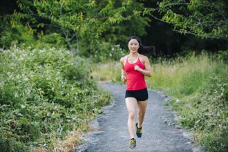 Korean woman running on remote path