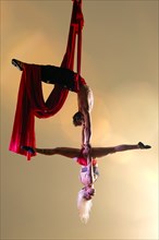 Caucasian acrobats performing with silk ropes