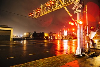 Illuminated traffic lights on railroad crossing at night