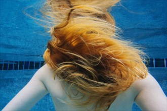 Caucasian woman underwater in swimming pool