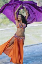 Belly dancer with arms raised