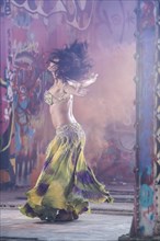 Belly dancer spinning on stage