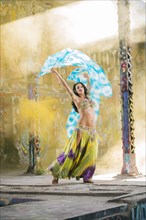 Belly dancer holding blue and white fabric