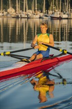 Caucasian man rowing on lake