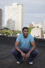 African American man standing on rooftop