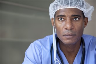 Black doctor in scrubs and surgical cap