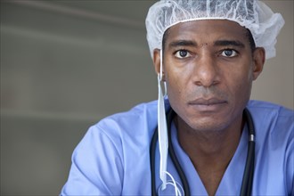 Black doctor in scrubs and surgical cap