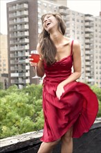 Glamorous mixed race woman drinking wine outdoors