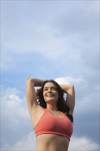 Woman in sportswear stretching outdoors