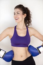 Smiling woman wearing boxing gloves