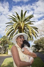 Senior Caucasian woman holding dog