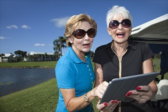 Senior Caucasian women looking at digital tablet