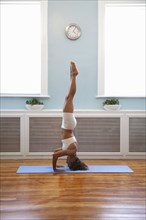 Mixed race woman practicing yoga