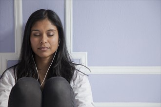 Sri Lankan woman listening to mp3 player