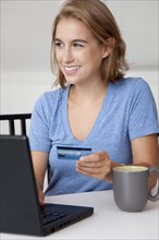 Caucasian woman shopping online with credit card