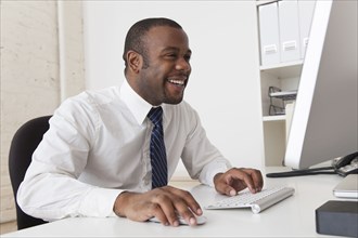 Black businessman using computer at desk